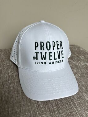 Proper No. Twelve Irish Whiskey white embroidered snapback trucker hat.